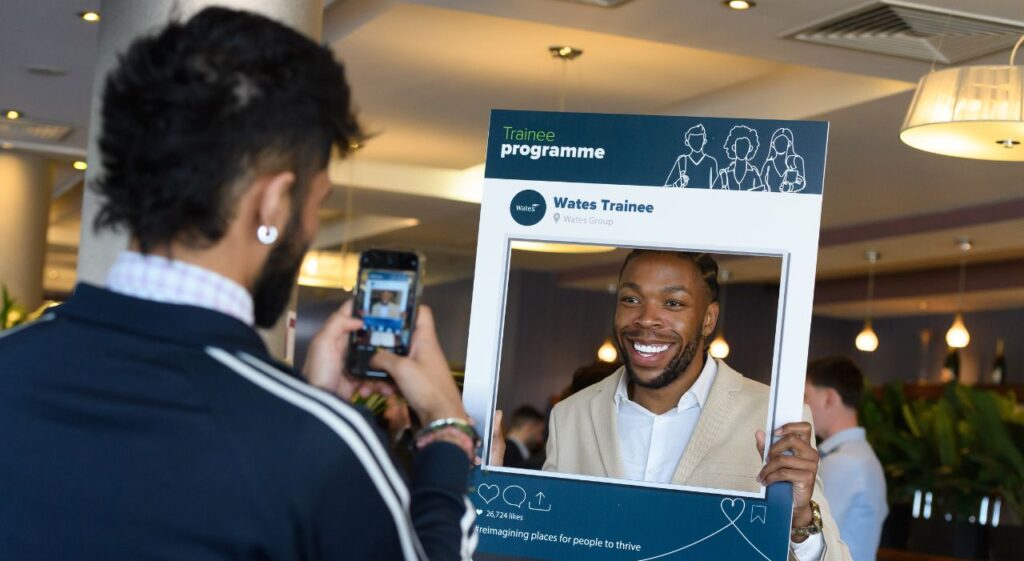 man smiling at promoted trainees event