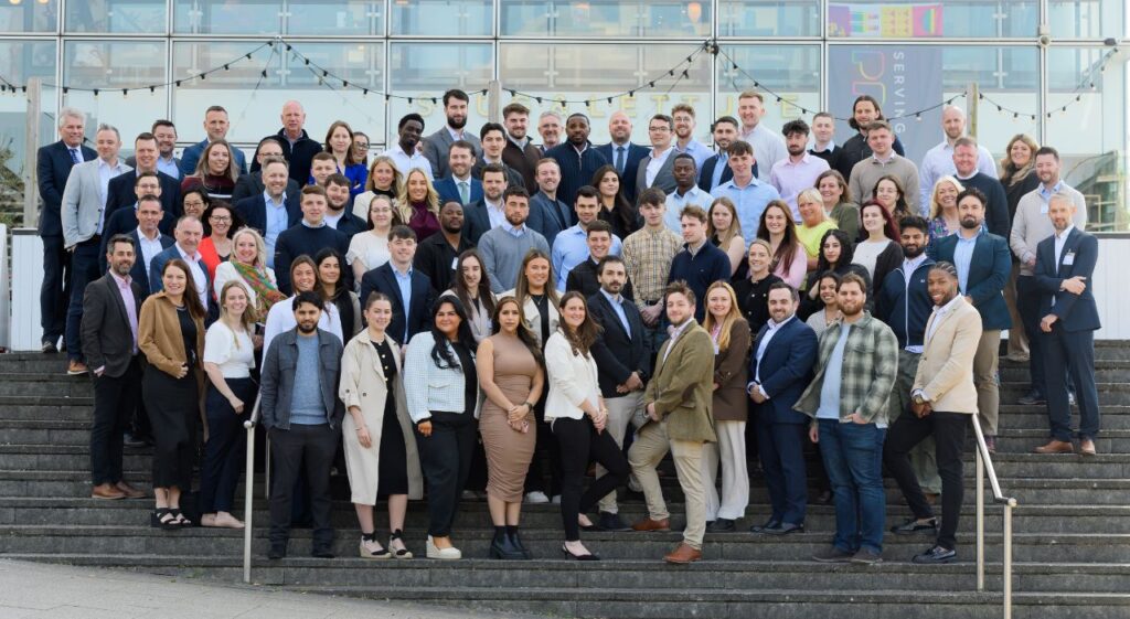 trainee celebration event with promoted trainees and stakeholders