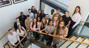 trainee celebration event nominees posing on the steps