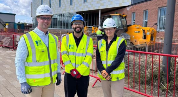 A group of Wates employees on a worksite posing